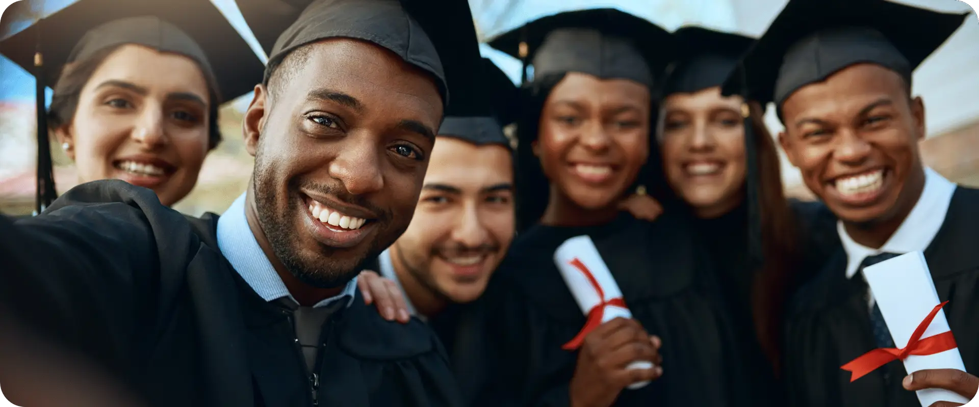 A group of college students in regalia during a comencement ceremony.