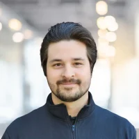 Portrait of a confident businessman smiling in a contemporary office environment.