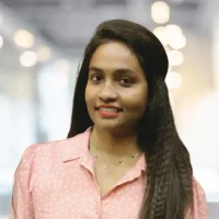 Woman smiling in professional attire at Canyon GBS office setting.