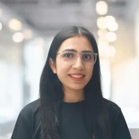 Professional woman with glasses in an office setting at Canyon GBS.