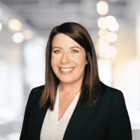 Professional woman smiling in business attire at Canyon GBS office.